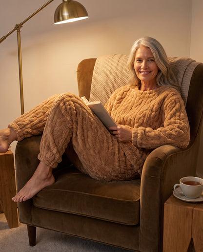 CLAIRE cable lounge set in Coffee Color, reading in an armchair