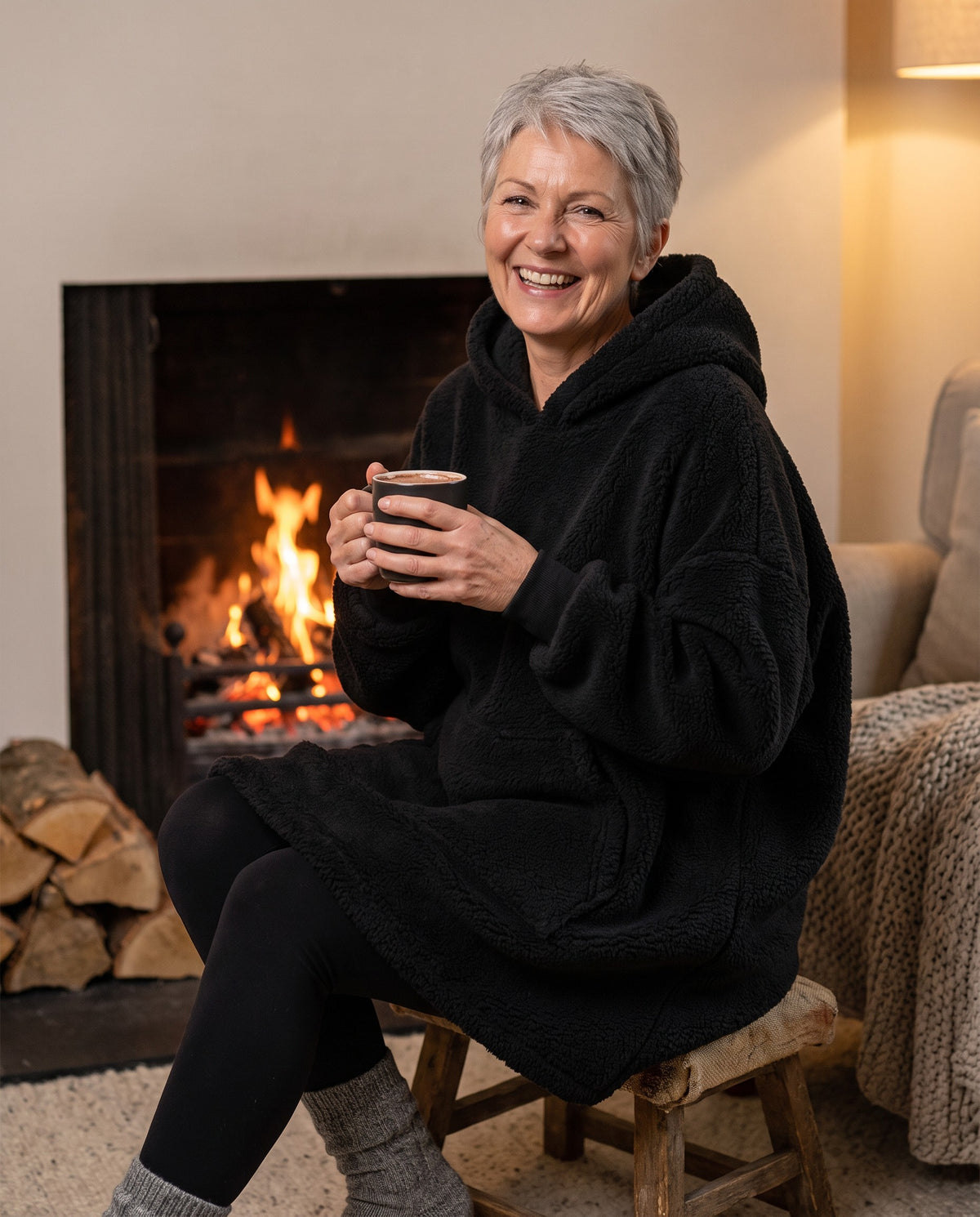 MAPLE hooded wearable blanket in Black, by the fire
