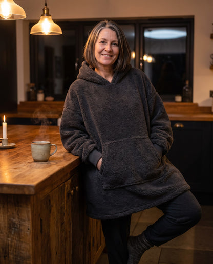 MAPLE hooded wearable blanket in Dark Grey, in the kitchen